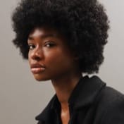 black beautiful woman with curly hair in black shirt